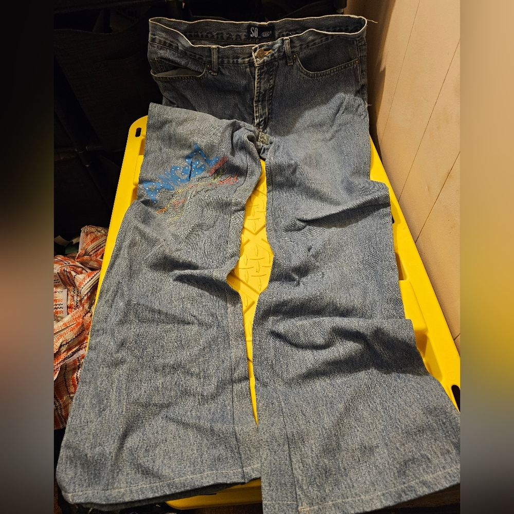 Vintage SO jeans with words on them.